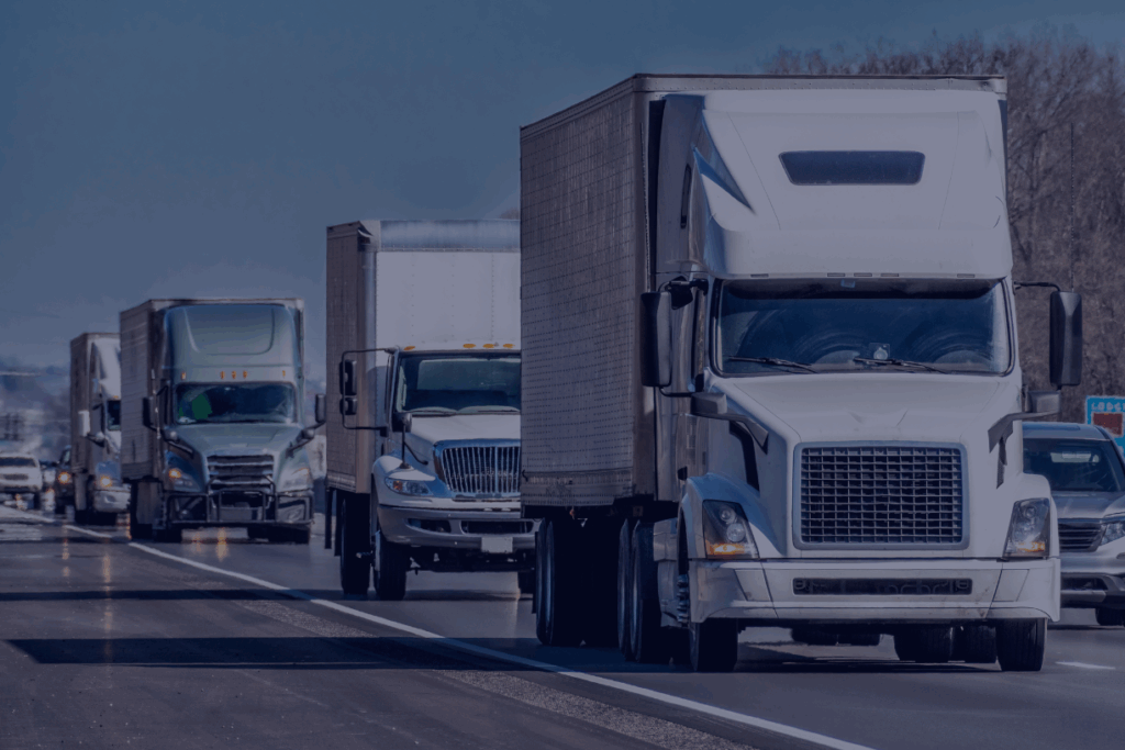 group of eighteen wheelers driving on highway